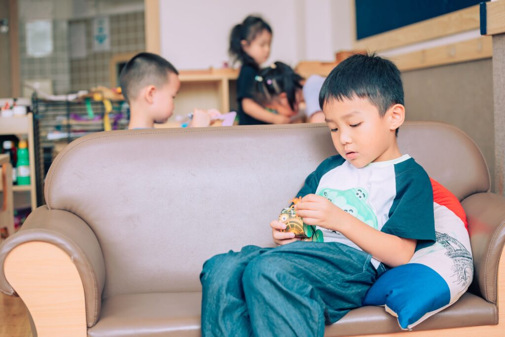 Children enjoying playtime in a comfortable indoor setting with toys and friends.